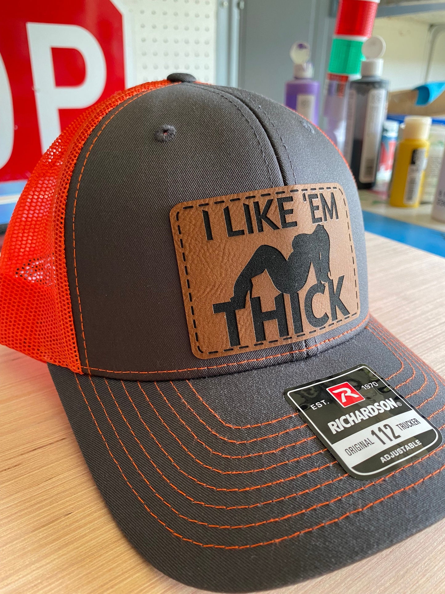 I Like 'Em Thick Leather Patch Trucker Hat