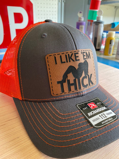 I Like 'Em Thick Leather Patch Trucker Hat