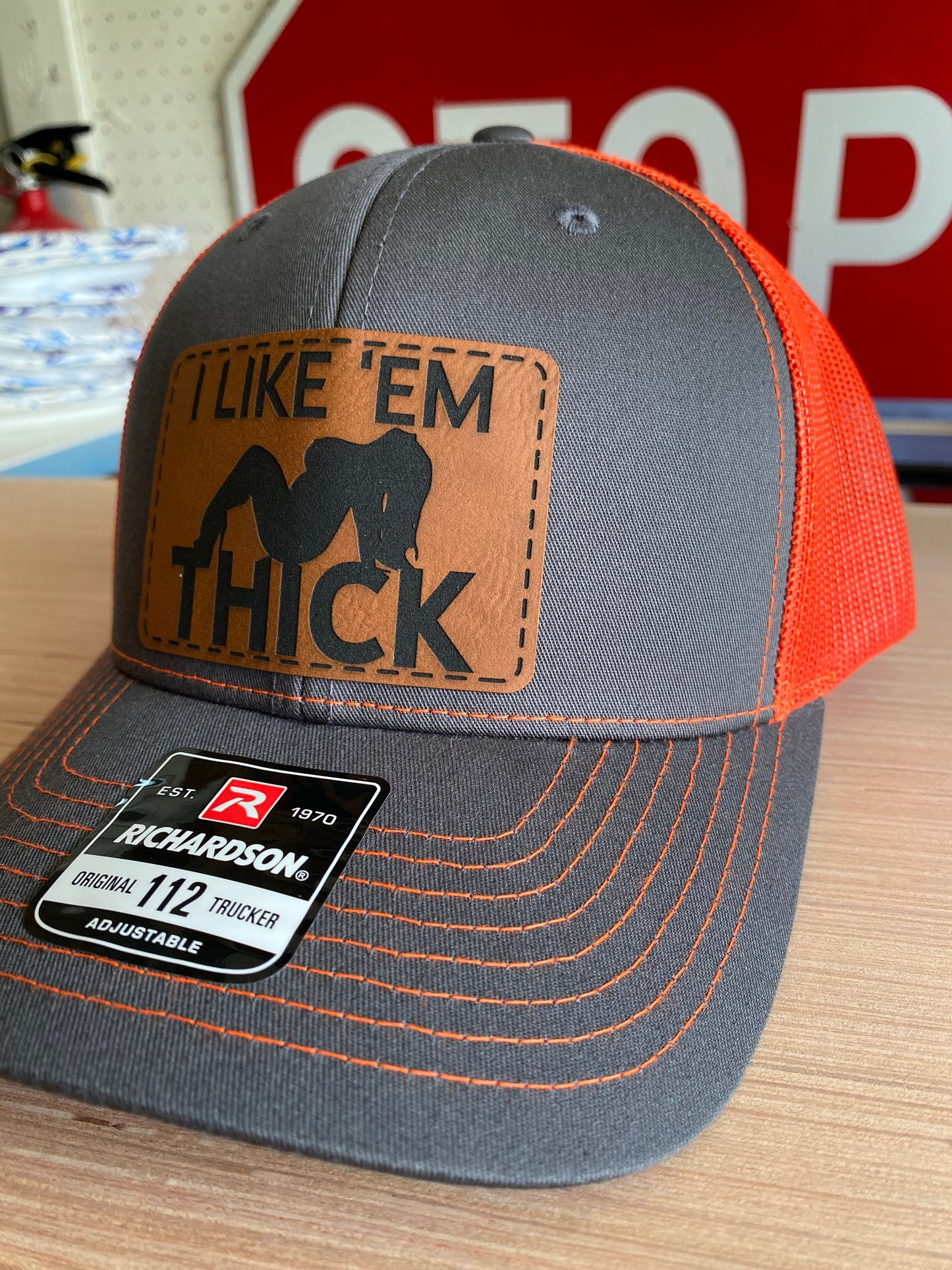 I Like 'Em Thick Leather Patch Trucker Hat