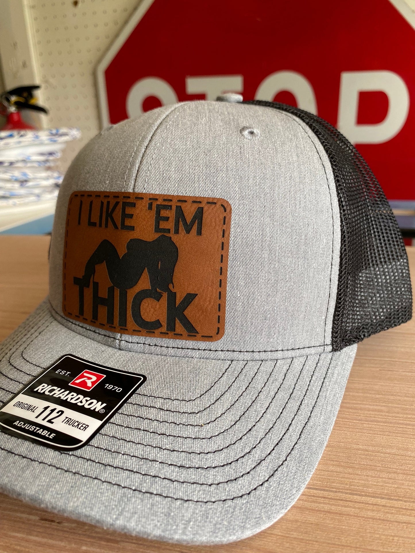 I Like 'Em Thick Leather Patch Trucker Hat